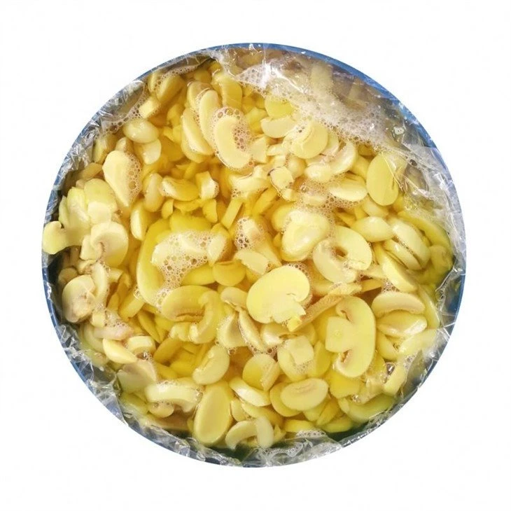 Sliced white champignon mushroom in salted water in barrel